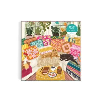 A jigsaw puzzle depicting a cozy scene with cats, pillows, and plants.
