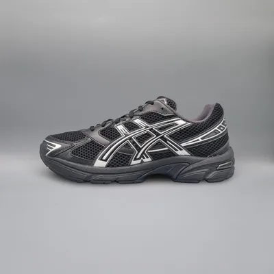 A black and white Asics running shoe is shown against a plain gray background.