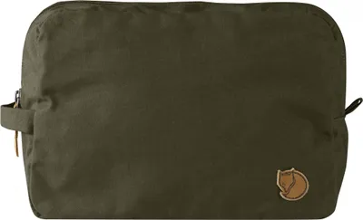 A green toiletry bag with a leather logo patch.