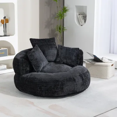 A dark gray beanbag chair with three pillows is shown in a room.