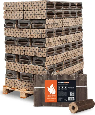 A large stack of firewood briquettes on a pallet, with a single briquette and a package in the foreground.