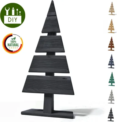 A black wooden Christmas tree decoration with several smaller colored Christmas trees on the right and two circular badges on the left.