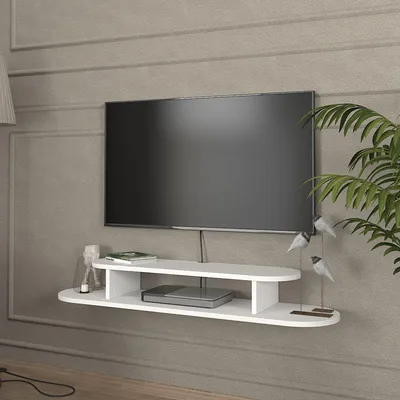 A white floating TV stand with a TV mounted above it, on a textured gray wall.