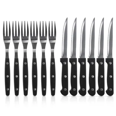 A set of steak knives and forks arranged neatly on a white background.