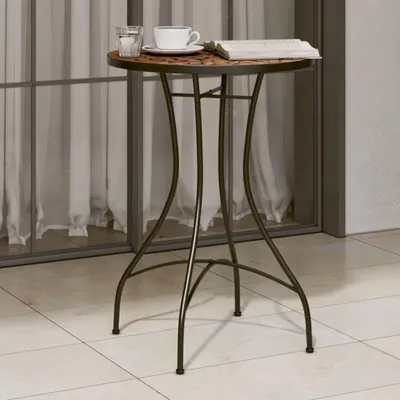 A small round bistro table with a mosaic top, a glass of water, a cup of coffee, and a newspaper on it, placed on a tiled patio in front of a glass door with sheer curtains.
