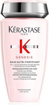 A product shot of a pink shampoo bottle with a silver cap.
