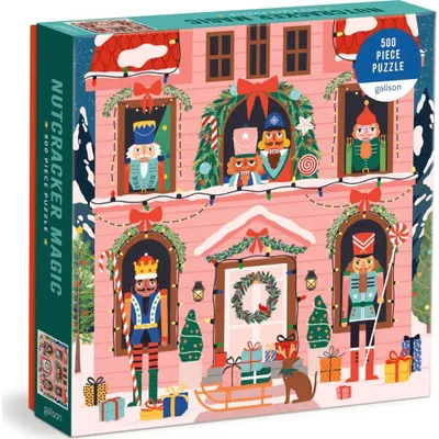 A box of a 500-piece jigsaw puzzle featuring a whimsical, festive scene of nutcrackers in and around a pink house decorated for Christmas.