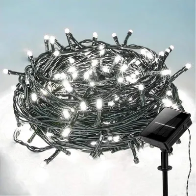 A tangled bundle of white LED string lights with a solar panel charger on a stand.