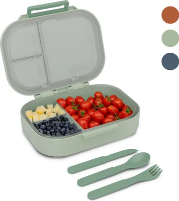 A green bento-style lunchbox filled with cherry tomatoes, blueberries, and diced cheese, with cutlery laid out in front.