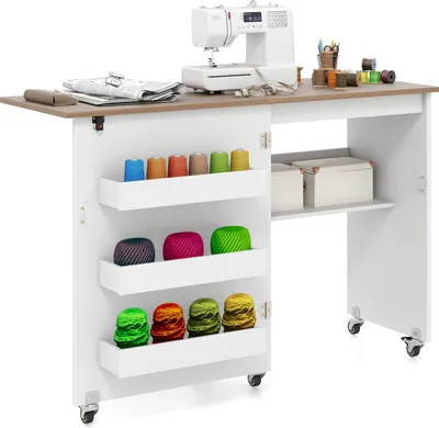 A sewing table with a sewing machine and various spools of thread on display.