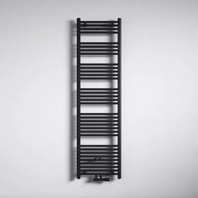 A black radiator is mounted on a white wall.