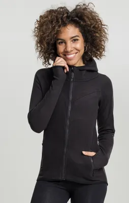A woman wearing a black zip-up hoodie.