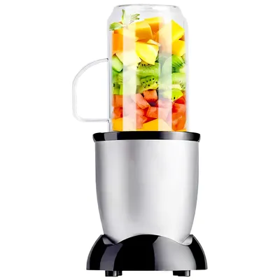 A blender with a glass cup filled with chopped fruits.