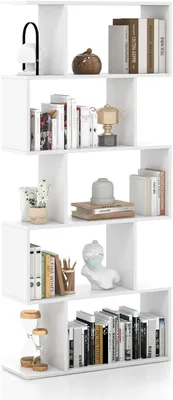 A white, multi-level bookshelf filled with books and decorative items, presented against a white background.