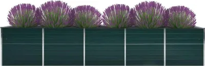A row of five purple plants in a dark green planter.