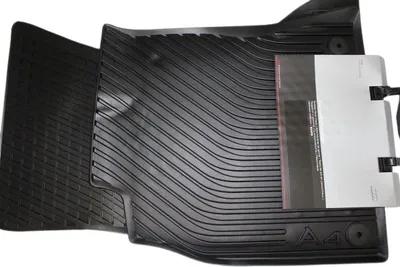 A black rubber car floor mat is shown on a white background.