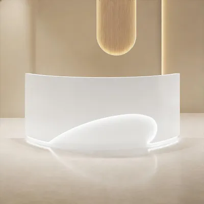 A modern, curved white reception desk with integrated lighting, set against a neutral beige wall and floor.
