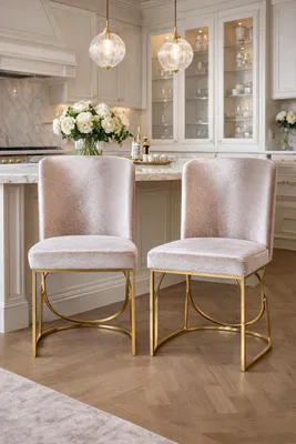 Image de Deux élégantes chaises en velours avec une structure métallique dorée, de style moderne