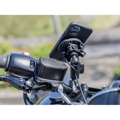 A close-up view of a motorcycle handlebar with a phone mount attached.