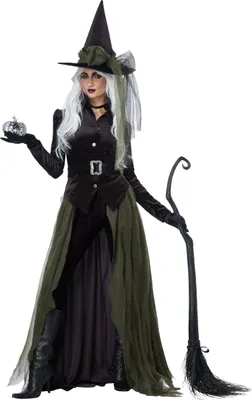 A woman dressed as a witch stands against a white background, holding a small pumpkin and a broom.