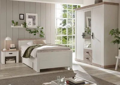 A bedroom scene featuring a bed, nightstand, and wardrobe.