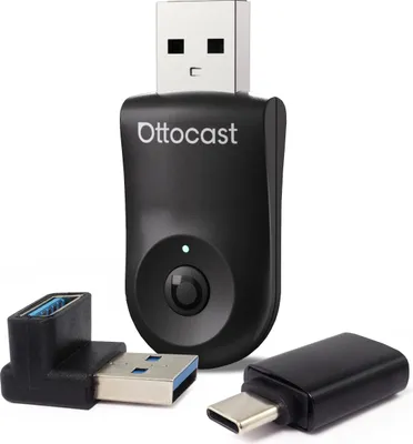 A black wireless CarPlay Android Auto adapter with two USB adapters on a white background.