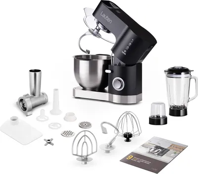 A black and silver kitchen machine with various attachments, a blender, and a booklet, displayed on a white background.