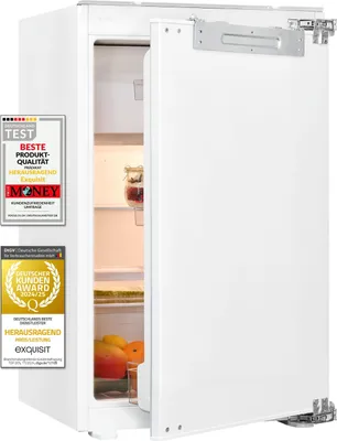 A white built-in refrigerator with its door open, showing the interior and some fruit. There are several award badges on the left side of the image.
