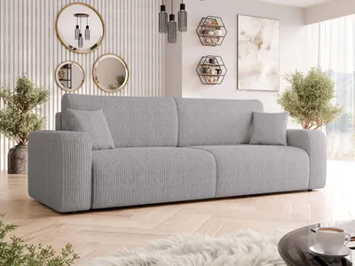 A modern living room with a grey sofa, decorative mirrors, and plants.