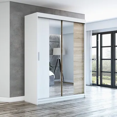 A modern bedroom with a sliding door wardrobe.