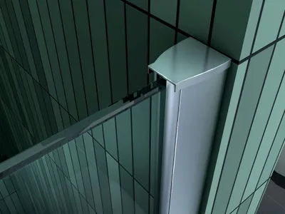 Close-up of a corner of a modern shower enclosure, showing the metallic frame and green glass panels.