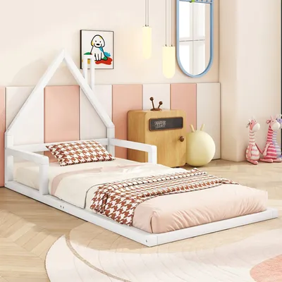 A child's bedroom with a white house-shaped bed, bedding, a wooden nightstand, and stuffed animals.