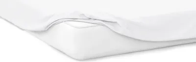 A close-up view of a white fitted sheet on a mattress.