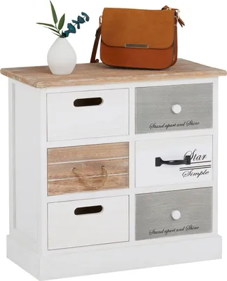 A vintage-style chest of drawers with six drawers, a brown handbag, and a small vase with greenery on top.