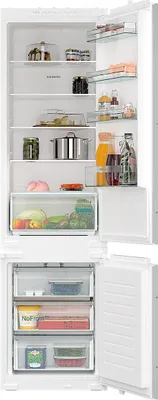 An open refrigerator with food items on the shelves and in drawers.
