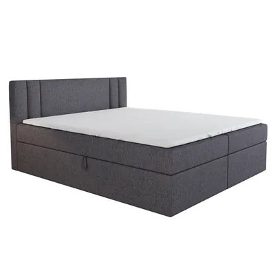 A dark gray boxspring bed with a white mattress and topper, shown from a side angle against a white background.