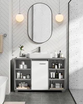 A bathroom vanity with a sink and mirror.
