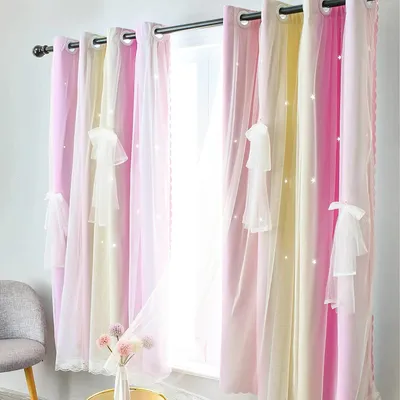 A window with curtains decorated with small white stars and bows.