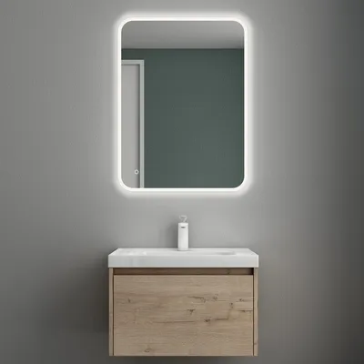 A bathroom vanity set with a sink and mirror against a gray wall.