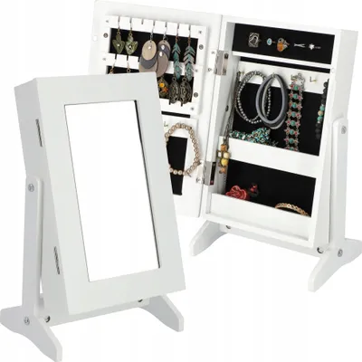 A white jewelry box with a mirror is open, displaying various jewelry items inside.