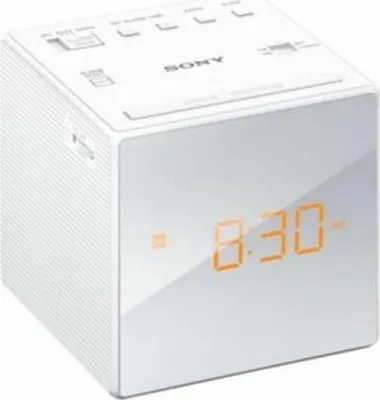 A white Sony cube-shaped digital alarm clock with an orange display showing the time.