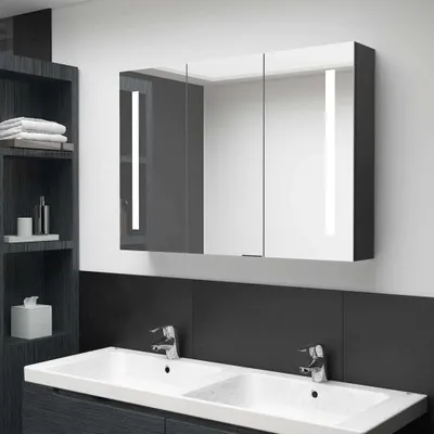 A modern bathroom vanity with a medicine cabinet and sinks.