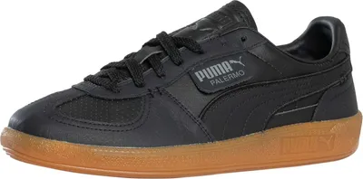 A black Puma Palermo sneaker with a gum sole is shown from a side angle against a white background.