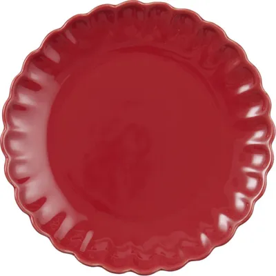 A red plate with a scalloped edge.