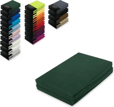 A stack of dark green fitted sheets is shown on a white background, with smaller stacks of fitted sheets in various colors visible in the upper left corner.