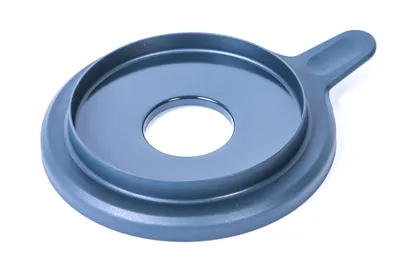 A gray plastic lid with a central hole and a handle is shown against a white background.
