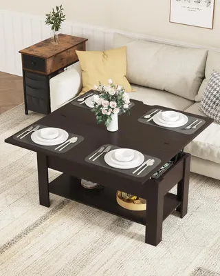 A living room scene with a coffee table set for dining, next to a couch.