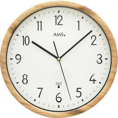A close-up, front-facing view of a round wall clock with a wooden frame.
