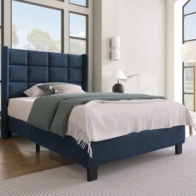 A bedroom scene with a blue upholstered bed.