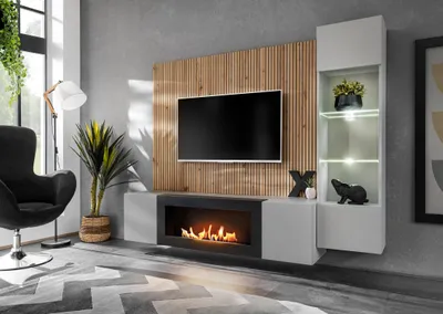 A modern living room with a wall-mounted entertainment unit featuring a TV, fireplace, and display shelves.